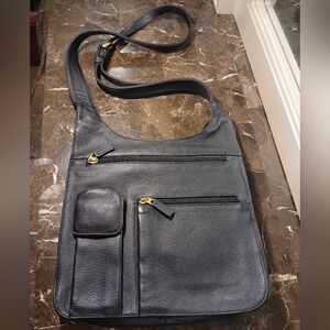 JP Ourse & Cie Traveler leather cross-body messenger bag.